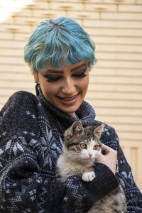 Side view of woman with cat