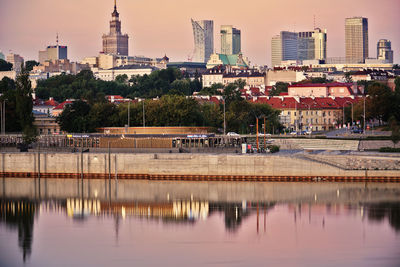 Reflection of buildings on lake in city