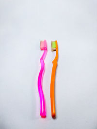 Close-up of colored pencils over white background