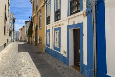 Empty alley amidst buildings in city