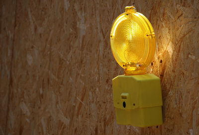 Close-up of yellow toy on wall