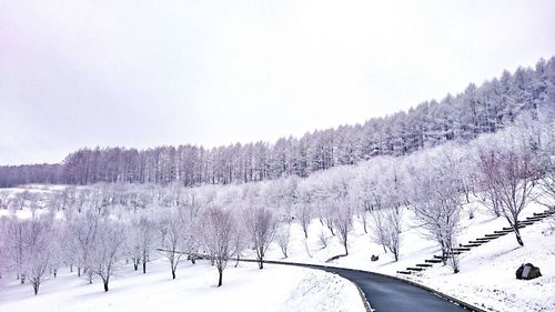 Panoramic view of snow covered landscape against sky