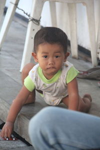 Portrait of cute baby girl sitting outdoors