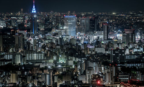 High angle view of illuminated city buildings at night