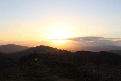 Scenic view of silhouette mountains against sky during sunset