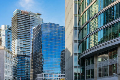 Low angle view of modern buildings in city against sky