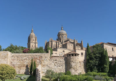 The ancient roman stone city walls and cathedral of the city of salamanca, spain