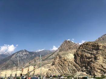 Panoramic view of mountain range against blue sky