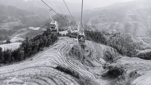 Paddy terraces and cable car in black and white in guilin china