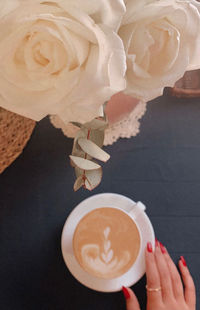 Cropped image of hand holding coffee cup