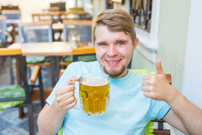 Portrait of a smiling man holding drink