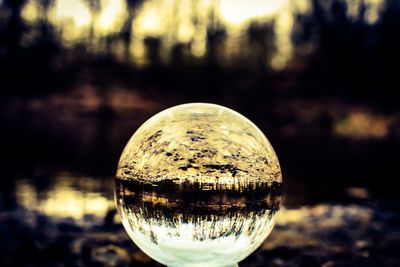 Close-up of crystal ball on glass