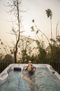Woman enjoying a bath in a hot tub in the sri lankan highlands