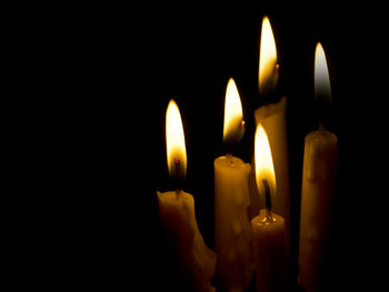 Close-up of lit candles in temple