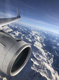 Aerial view of aircraft wing against sky