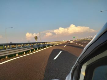 Road against sky seen from car windshield