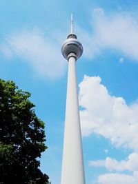 Low angle view of tower against cloudy sky