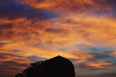 Low angle view of cloudy sky at sunset