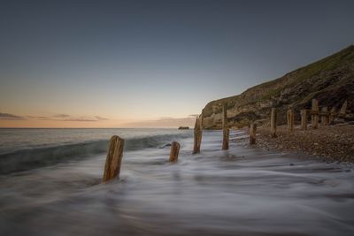 Scenic view of beach against clear sky