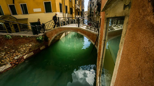 High angle view of canal amidst buildings