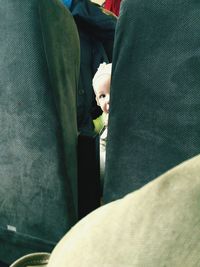 Portrait of cute baby looking through vehicle seats