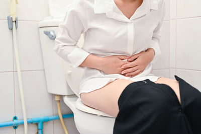 Midsection of woman in bathroom