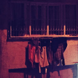 Clothes drying against building wall at night