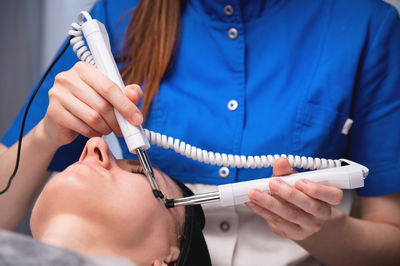 Midsection of doctor examining patient