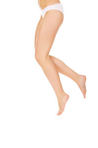 Low section of woman standing against white background