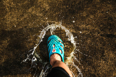 Low section of person splashing water