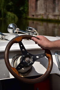 Close-up of person driving yacht