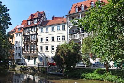 Buildings and trees against sky