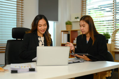 Businesswoman using laptop at office