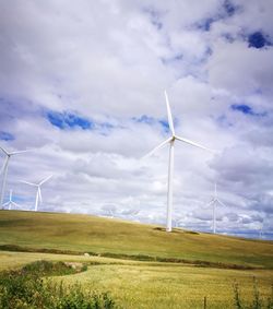 View of windmill on field against sky