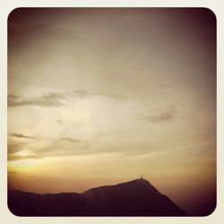 Scenic view of mountains against sky at sunset