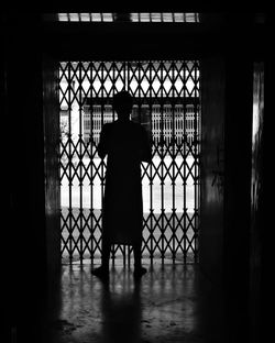 Silhouette of man standing in corridor