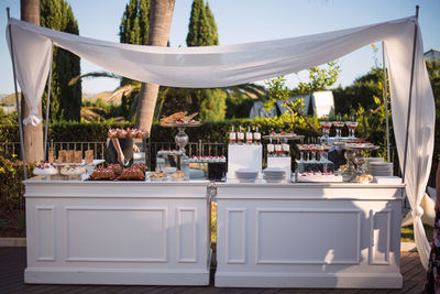 Table and chairs in yard against clear sky