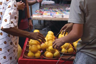 Midsection of man preparing food at market stall