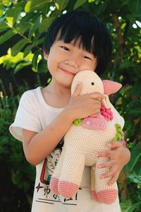 Portrait of cute boy holding toy