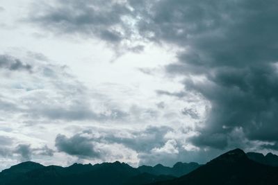 Low angle view of mountain against cloudy sky