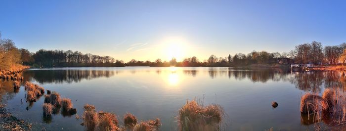 Scenic view of lake against sky during sunset