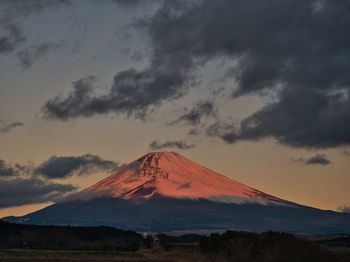Scenic view of snowcapped mountains against sky during sunset