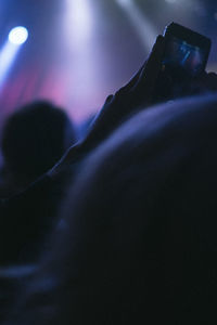 Close up of man photographing at concert