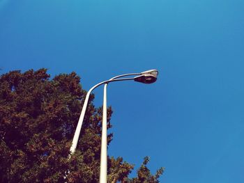 Low angle view of flag against clear blue sky