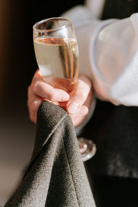 Cropped hand holding wineglass