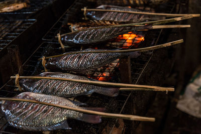 High angle view of fish roasting on barbecue grill