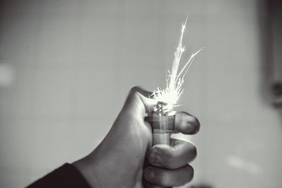 Blurred image of hand holding illuminated lighter