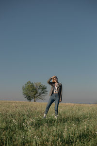 Full length of woman on field against clear sky
