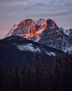 Scenic view of snowcapped mountains against sky during sunrise