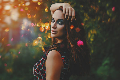 Side view portrait of mid adult woman in park during sunset